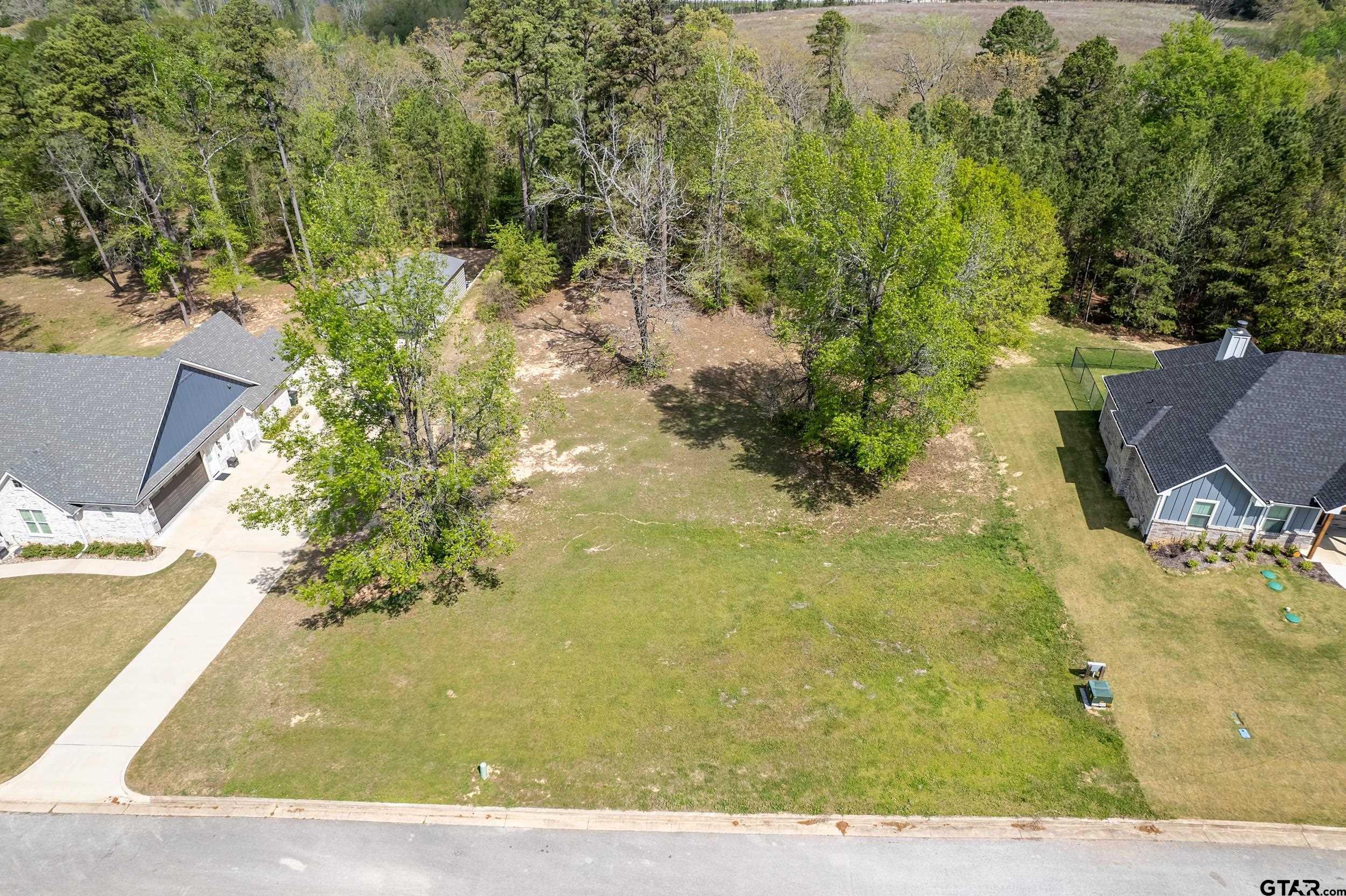24070 Sun Ridge Road Lindale, TX 75771 - Photo 2 of 20 a view of a yard with an outdoor space