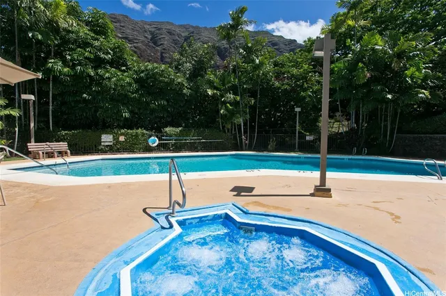 a view of a swimming pool with a yard