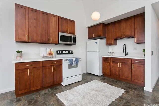 a kitchen with stainless steel appliances granite countertop a refrigerator stove top oven a sink and dishwasher