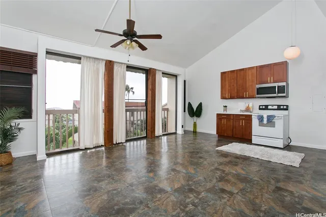 a view of kitchen with furniture flat screen tv and outdoor space