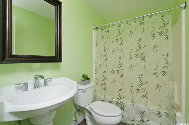 a bathroom with a sink a toilet and a mirror