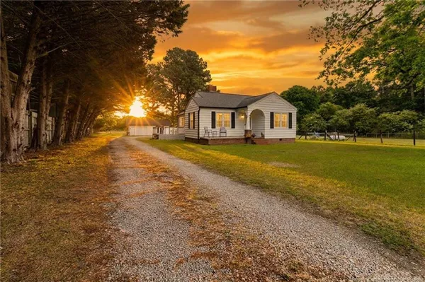 a view of a yard with a house in the background
