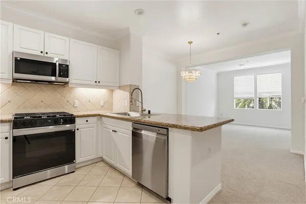 a kitchen with stainless steel appliances granite countertop a stove and a sink