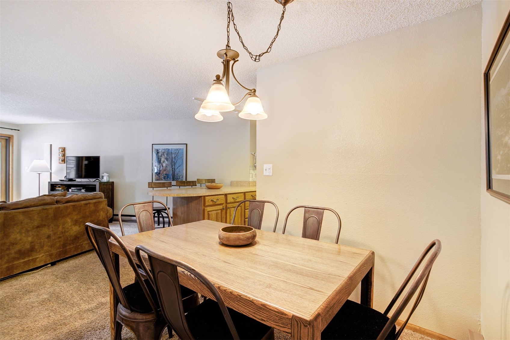 400 4 O Clock Road, Unit A Breckenridge, CO 80424 - Photo 10 of 31 Dining area featuring a textured ceiling and light carpet