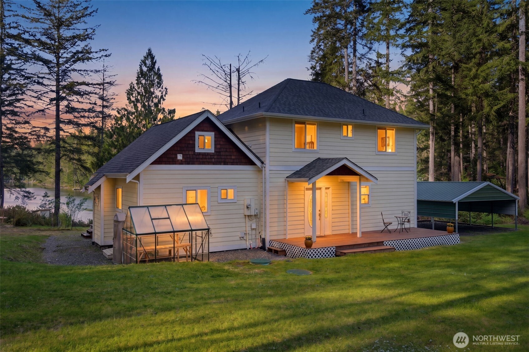 6971 Northeast Tahuya Blacksmith Road Belfair, WA 98528 - Photo 1 of 38 a front view of a house with a garden