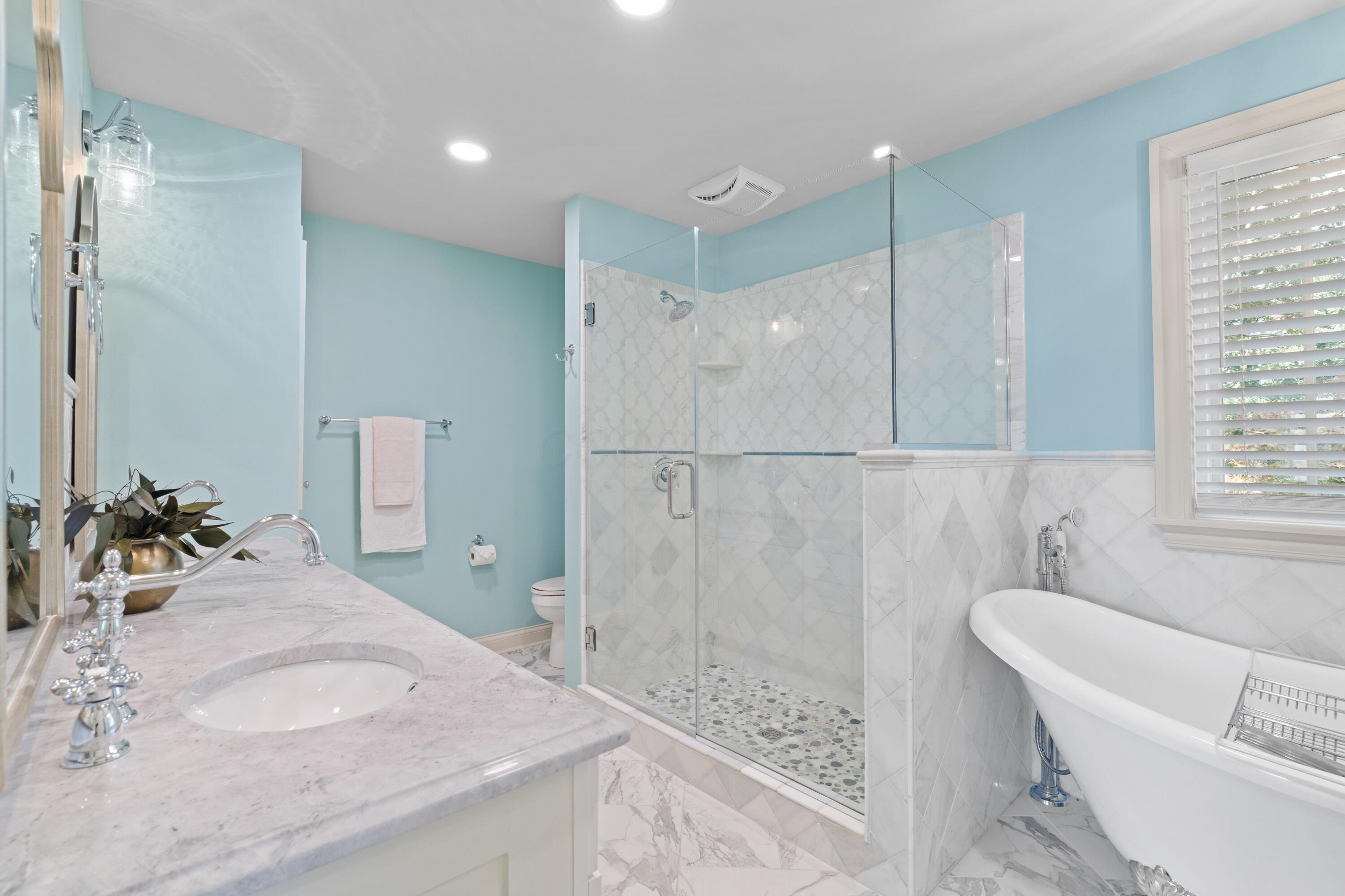 1326 Windham Road Columbus, OH 43220 - Photo 29 of 67 Marble-top double vanity with backsplash, stunning chrome hardware and soft-close cabinetry. Frameless glass shower with pebble floor and marble tile surround. Clawfoot free-standing soaking tub is perfect for relaxing after a long day! Lots of storage with 2 built-in linen closets, too!