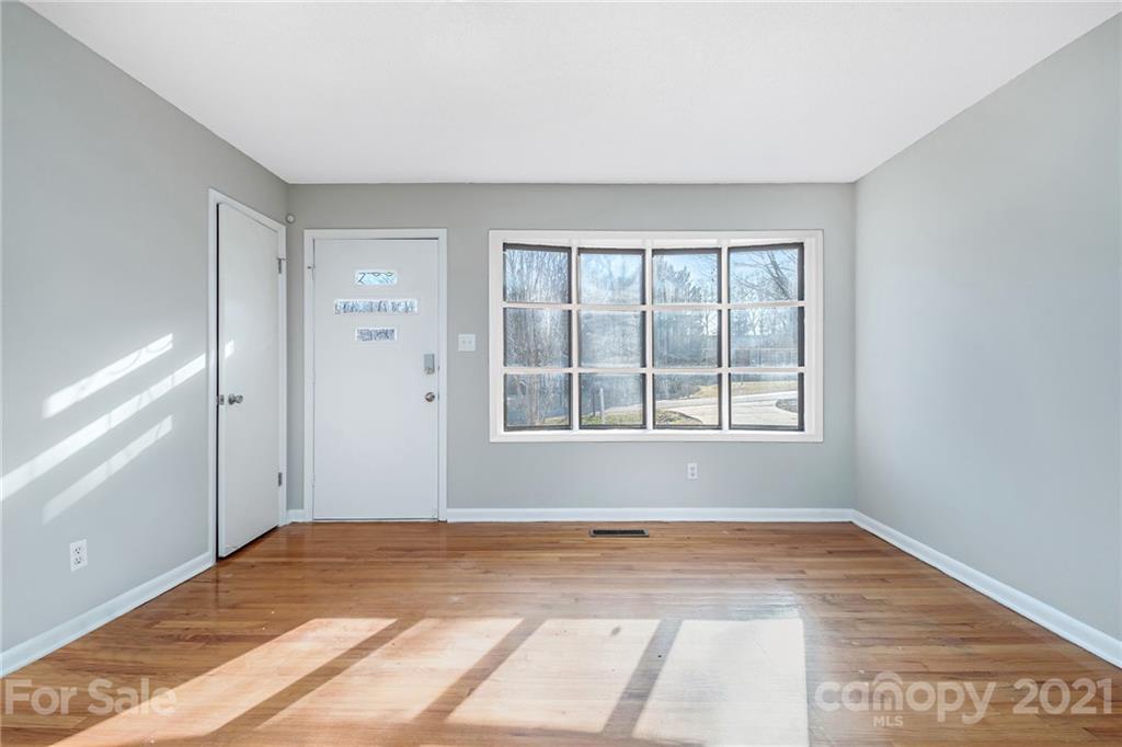135 Eller Road Gastonia, NC 28056 - Photo 2 of 17 a view of an empty room with wooden floor and a window