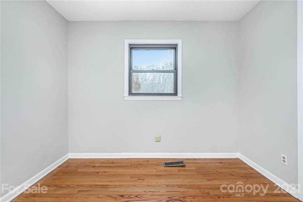 135 Eller Road Gastonia, NC 28056 - Photo 15 of 17 a view of an empty room with wooden floor and a window