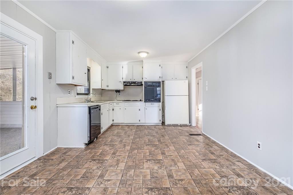 135 Eller Road Gastonia, NC 28056 - Photo 7 of 17 a kitchen with a stove a refrigerator and white cabinets