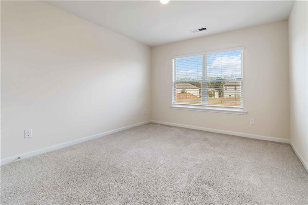 156 Beaumont Way Hampton, GA 30228 - Photo 17 of 21 an empty room with a window