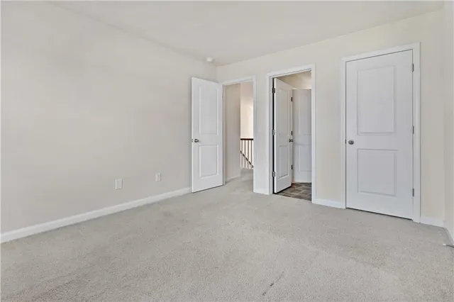 a view of an empty room and closet area