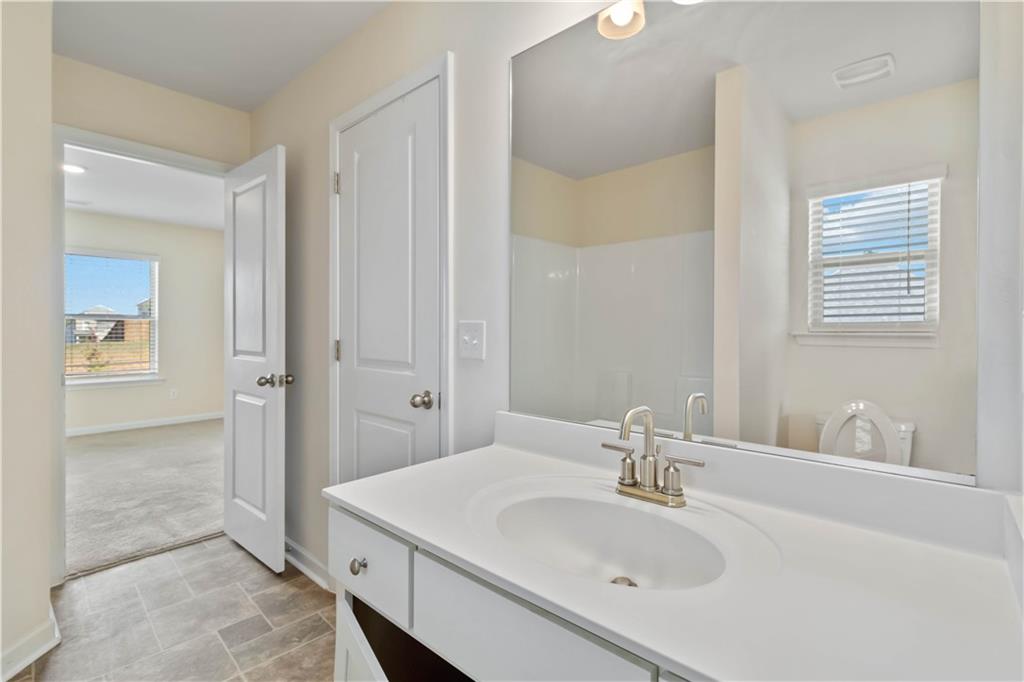 156 Beaumont Way Hampton, GA 30228 - Photo 19 of 21 a bathroom with a sink and a mirror
