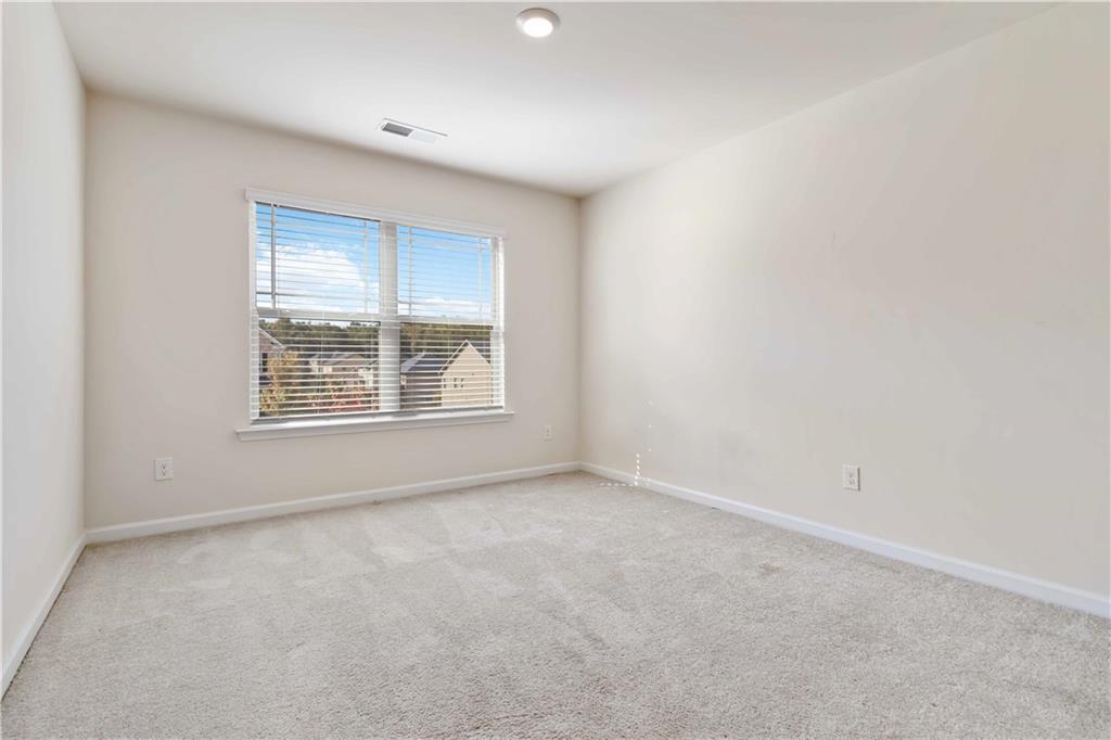 156 Beaumont Way Hampton, GA 30228 - Photo 20 of 21 an empty room with windows