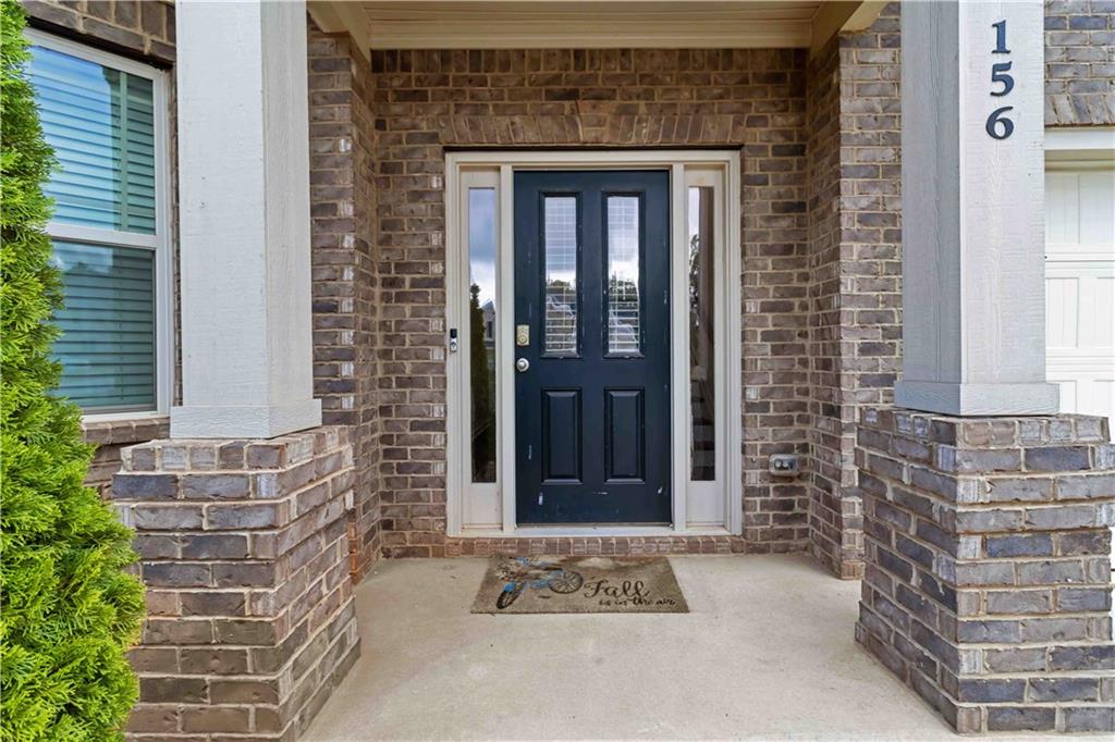 156 Beaumont Way Hampton, GA 30228 - Photo 2 of 21 a front view of a house with a garden