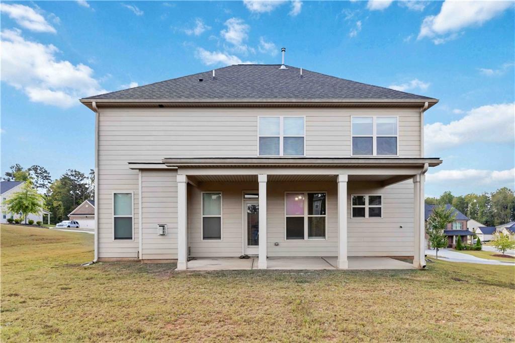 156 Beaumont Way Hampton, GA 30228 - Photo 21 of 21 a front view of a house with a garden