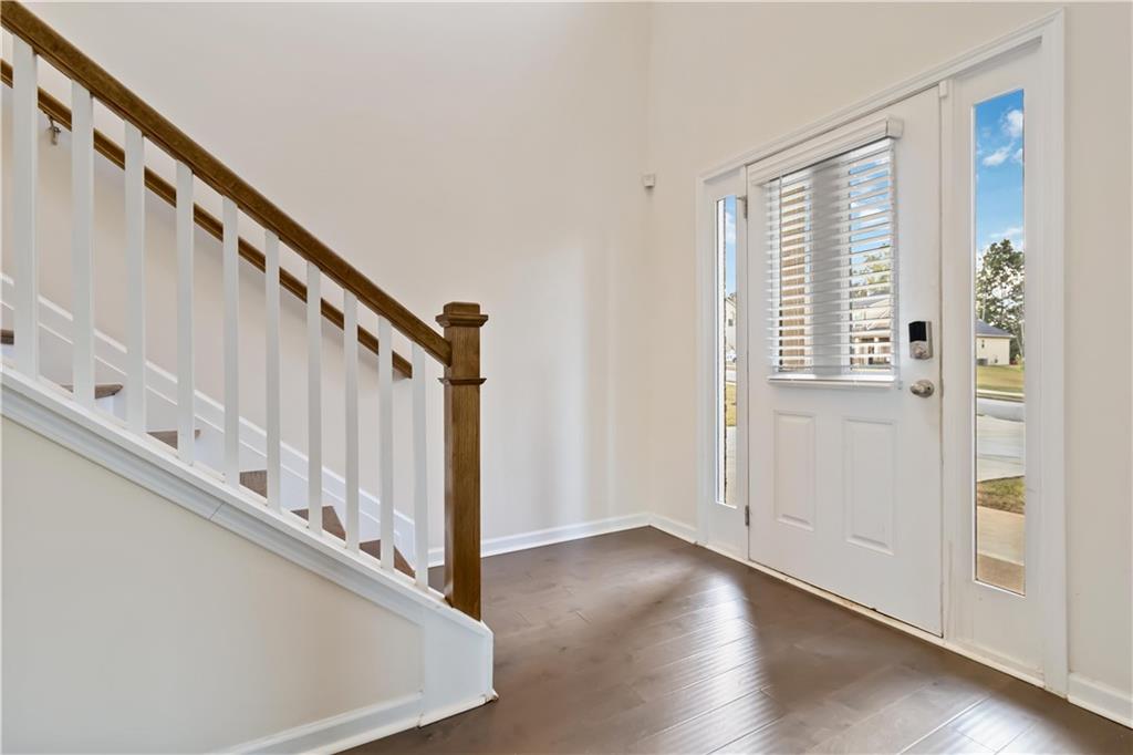 156 Beaumont Way Hampton, GA 30228 - Photo 3 of 21 a view of entryway with wooden floor and stairs