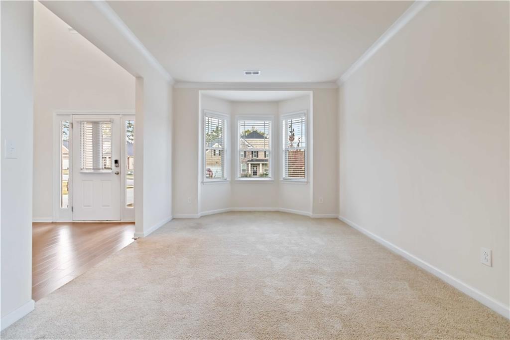 156 Beaumont Way Hampton, GA 30228 - Photo 4 of 21 an empty room that has a window