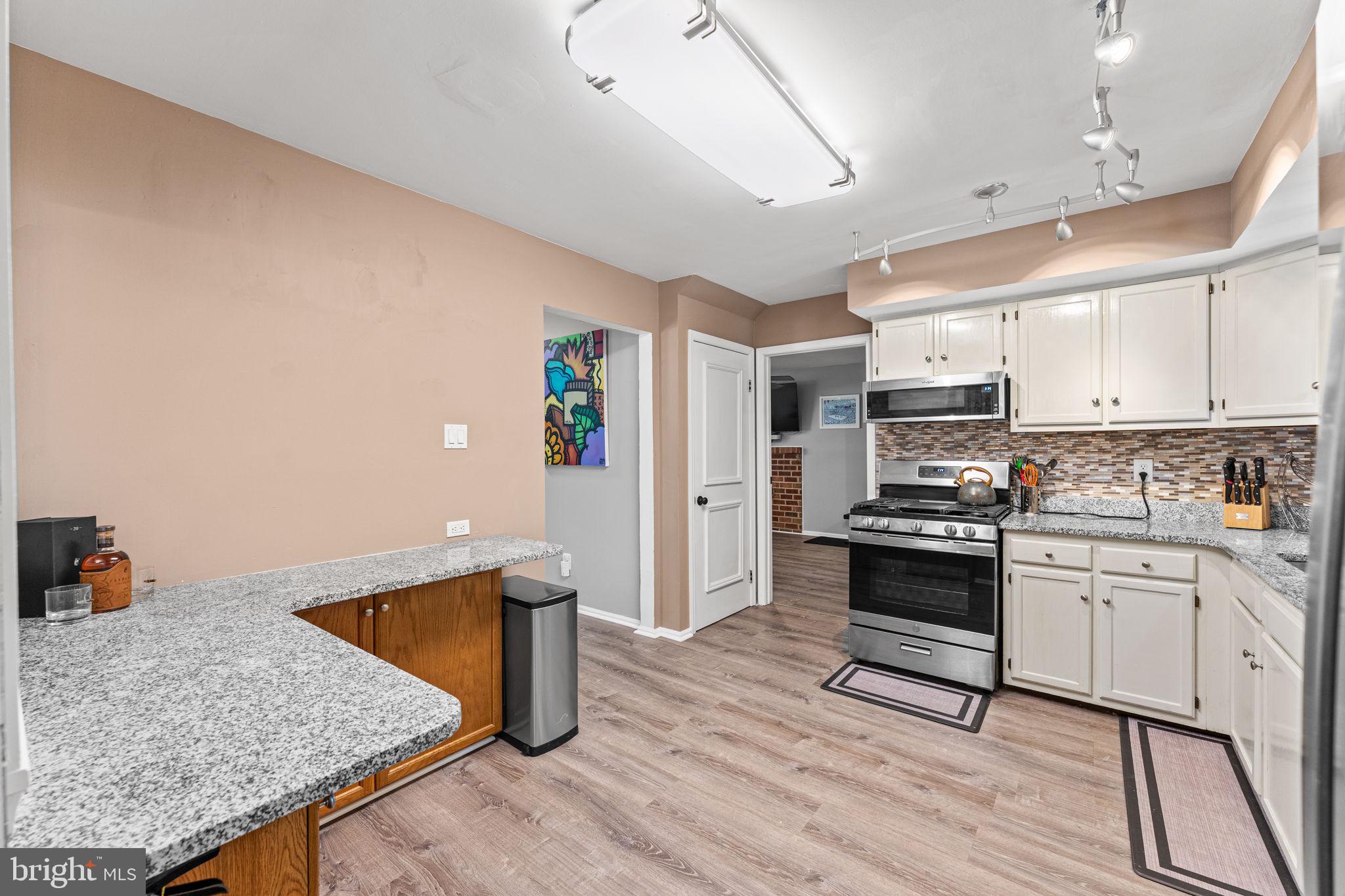 182 Wagon Wheel Road Norristown, PA 19403 - Photo 19 of 44 a kitchen with stainless steel appliances granite countertop a stove top oven a sink a counter space and cabinets