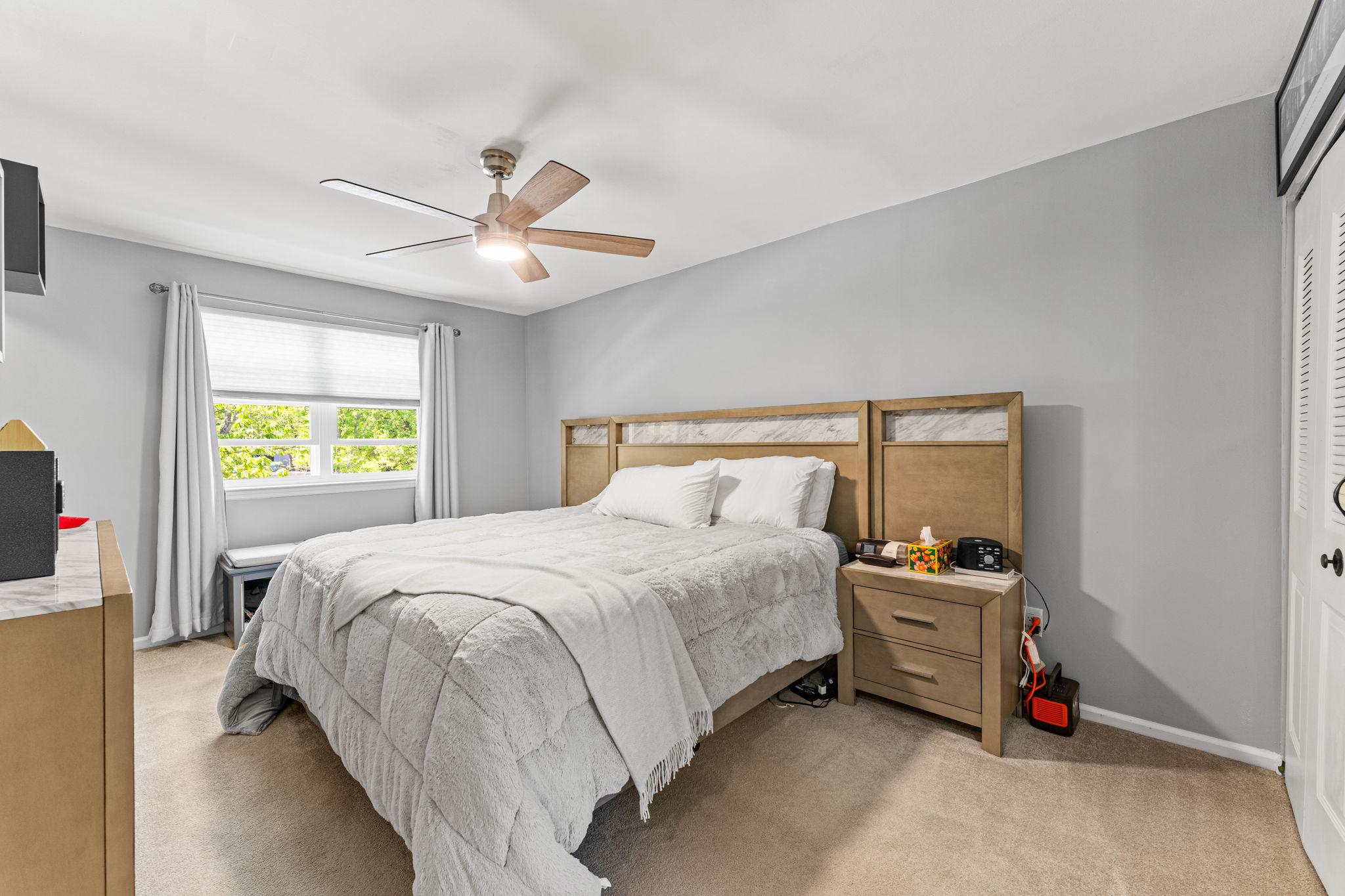 182 Wagon Wheel Road Norristown, PA 19403 - Photo 26 of 44 a bedroom with a bed and a chandelier