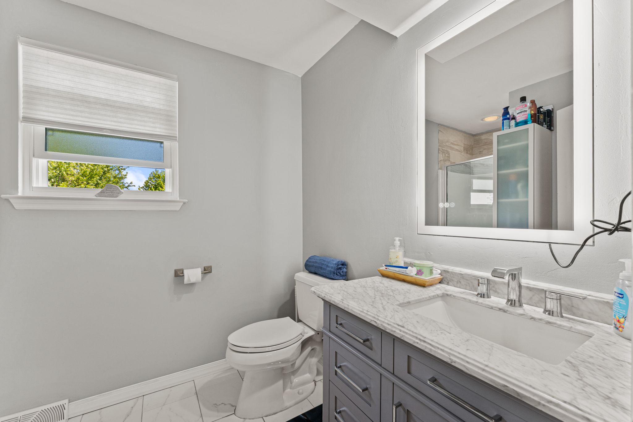 182 Wagon Wheel Road Norristown, PA 19403 - Photo 30 of 44 a bathroom with a granite countertop toilet sink and mirror