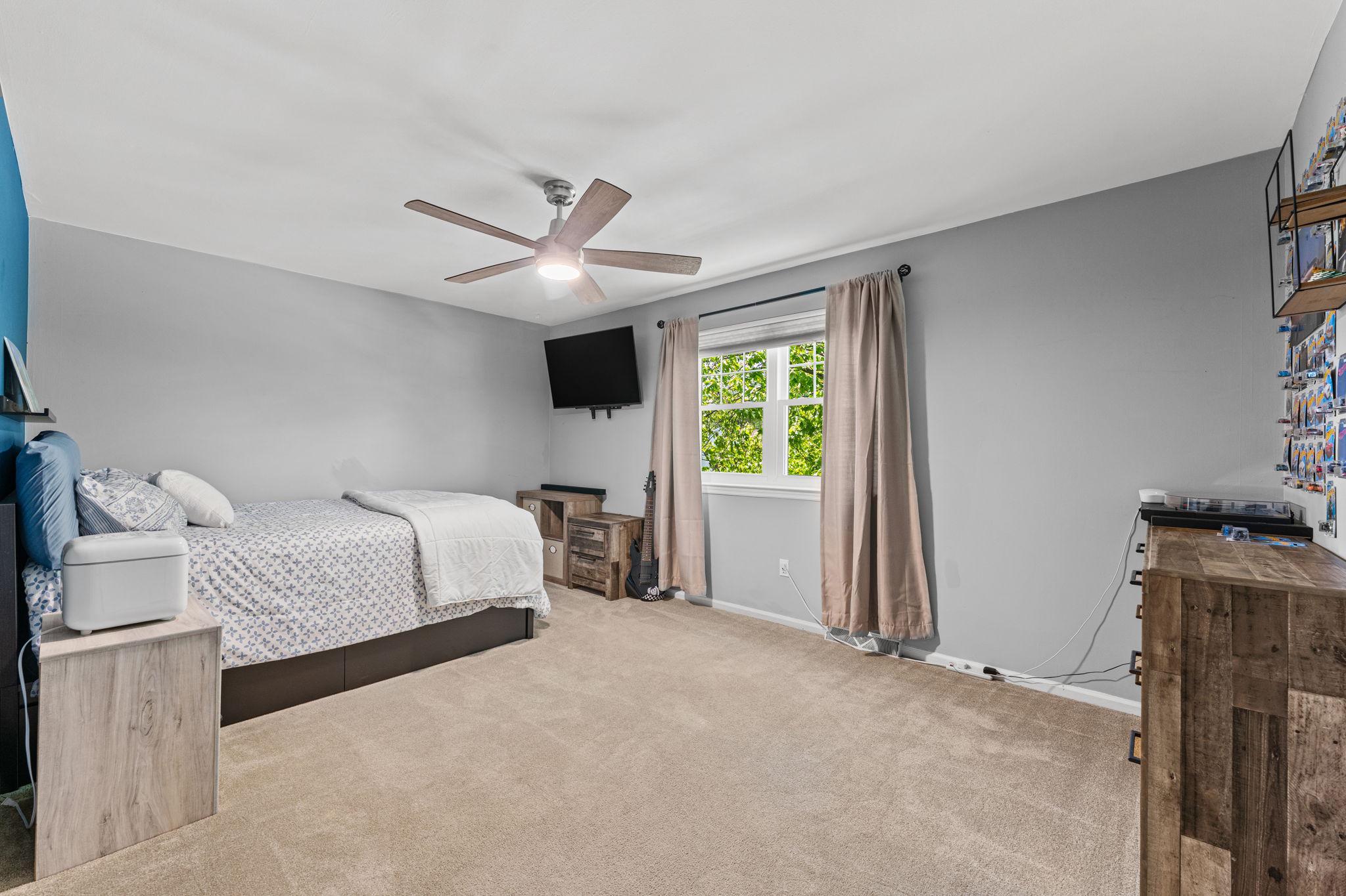 182 Wagon Wheel Road Norristown, PA 19403 - Photo 32 of 44 a bedroom with a bed and a ceiling fan
