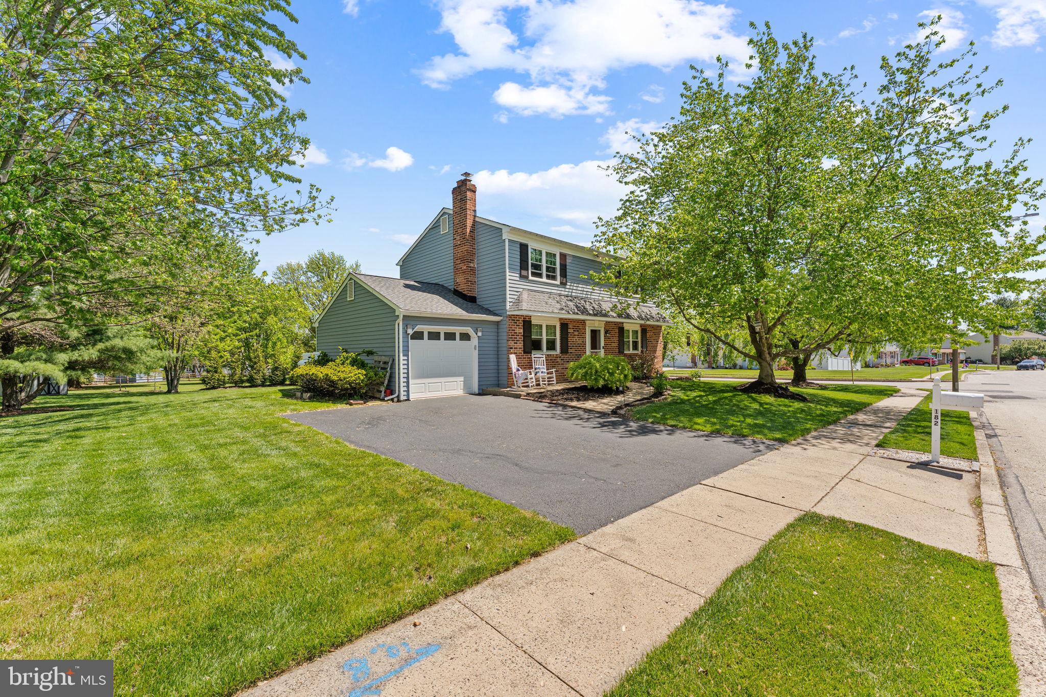 182 Wagon Wheel Road Norristown, PA 19403 - Photo 5 of 44 a front view of a house with a yard and trees
