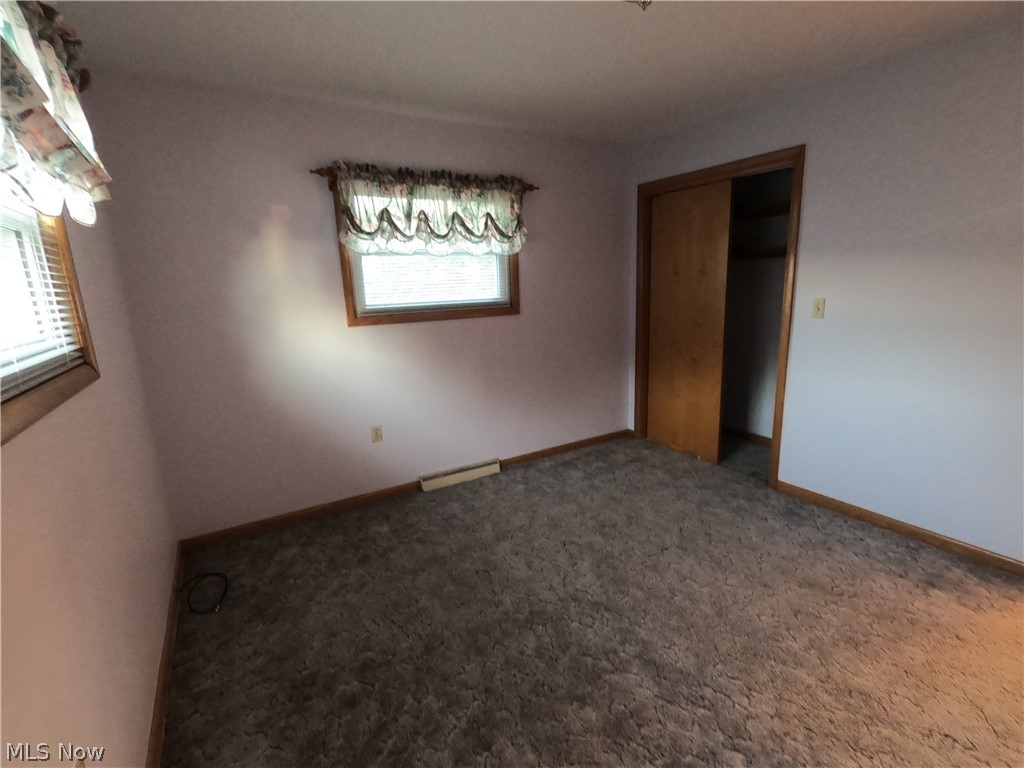 2586 Batdorf Road Wooster, OH 44691 - Photo 13 of 33 Unfurnished bedroom featuring a closet, carpet floors, and multiple windows