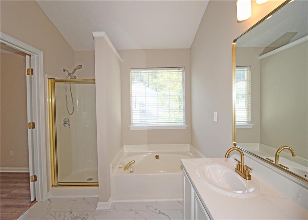 1334 Ambercrest Way Austell, GA 30168 - Photo 14 of 20 a bathroom with a tub sink and mirror