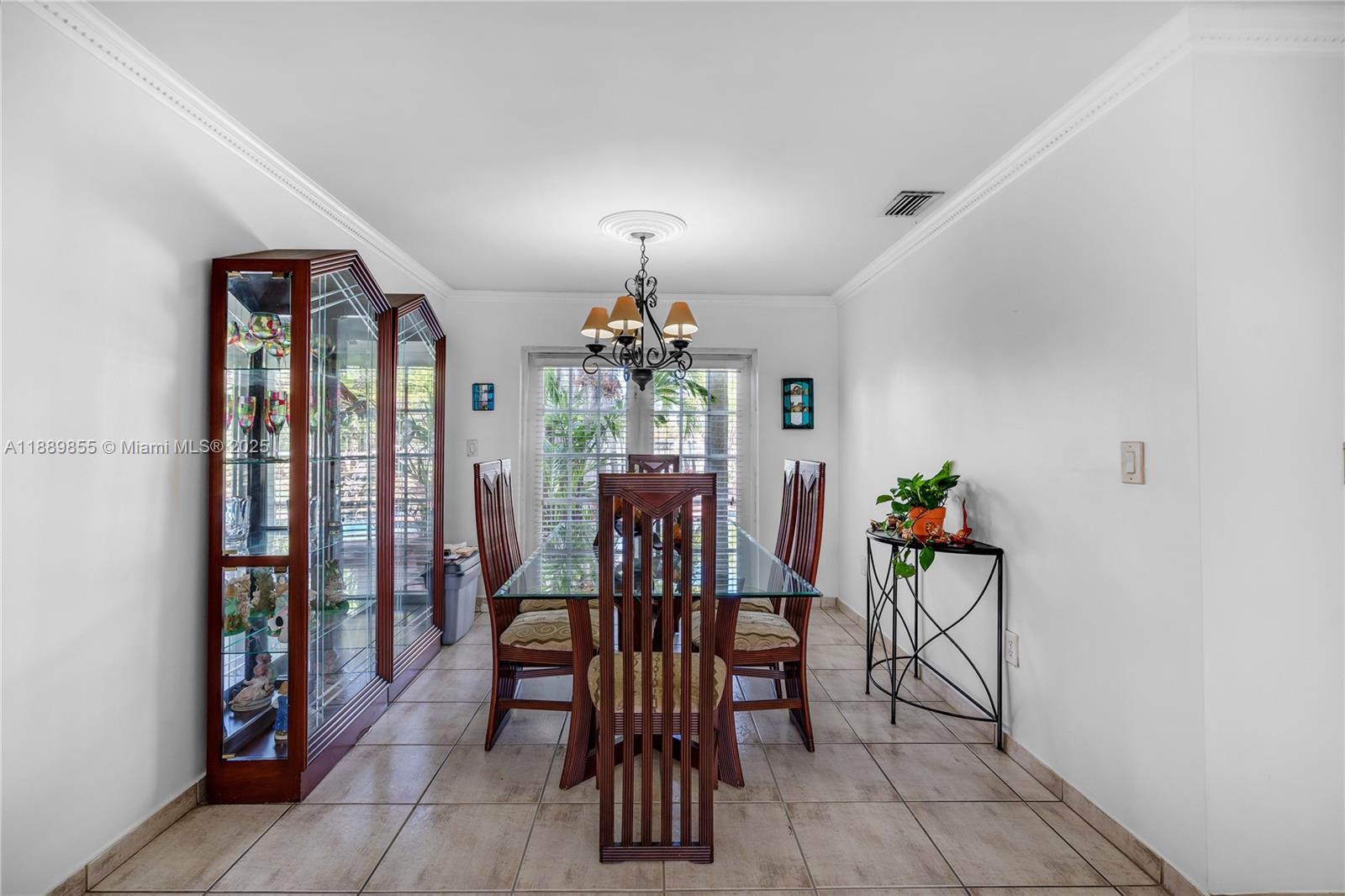 10213 Southwest 156th Avenue Miami, FL 33196 - Photo 12 of 29 a dining room with furniture a chandelier and window