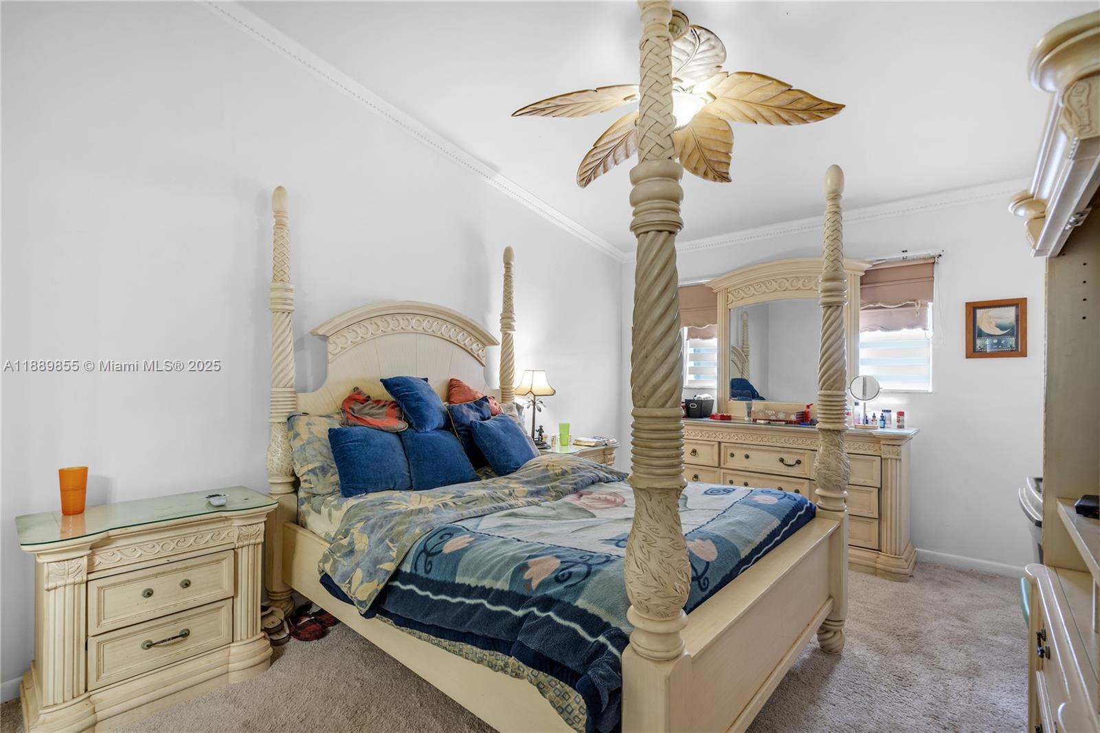 10213 Southwest 156th Avenue Miami, FL 33196 - Photo 15 of 29 a bedroom with a bed and a chandelier