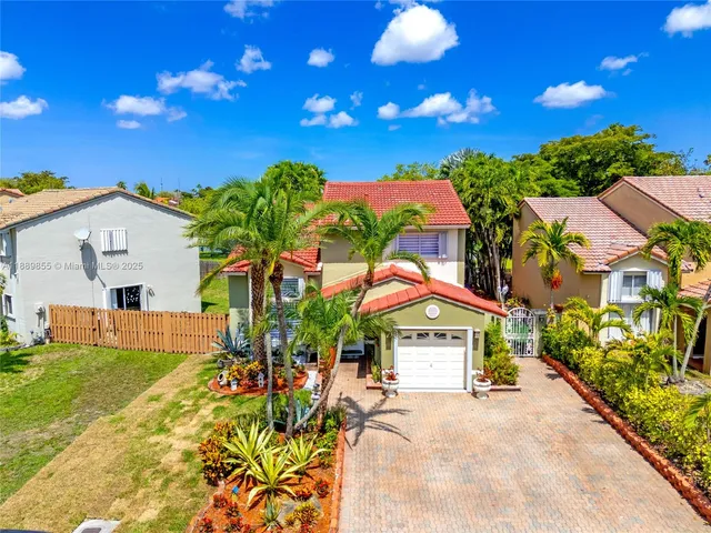 a view of house with outdoor space and swimming pool