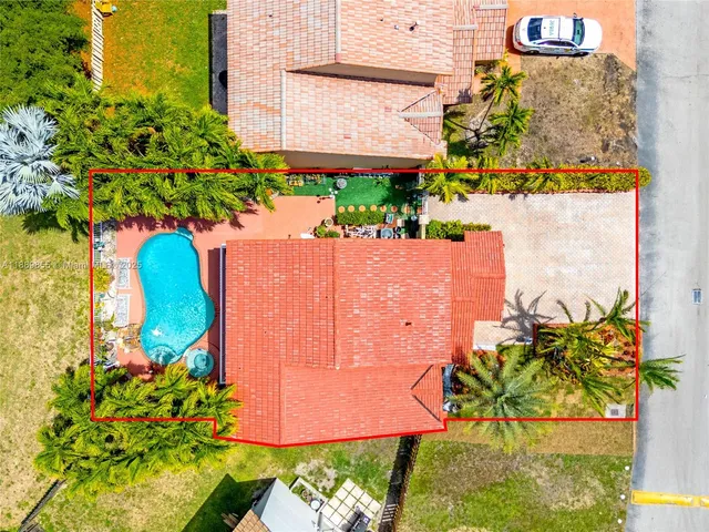 an aerial view of residential houses with outdoor space