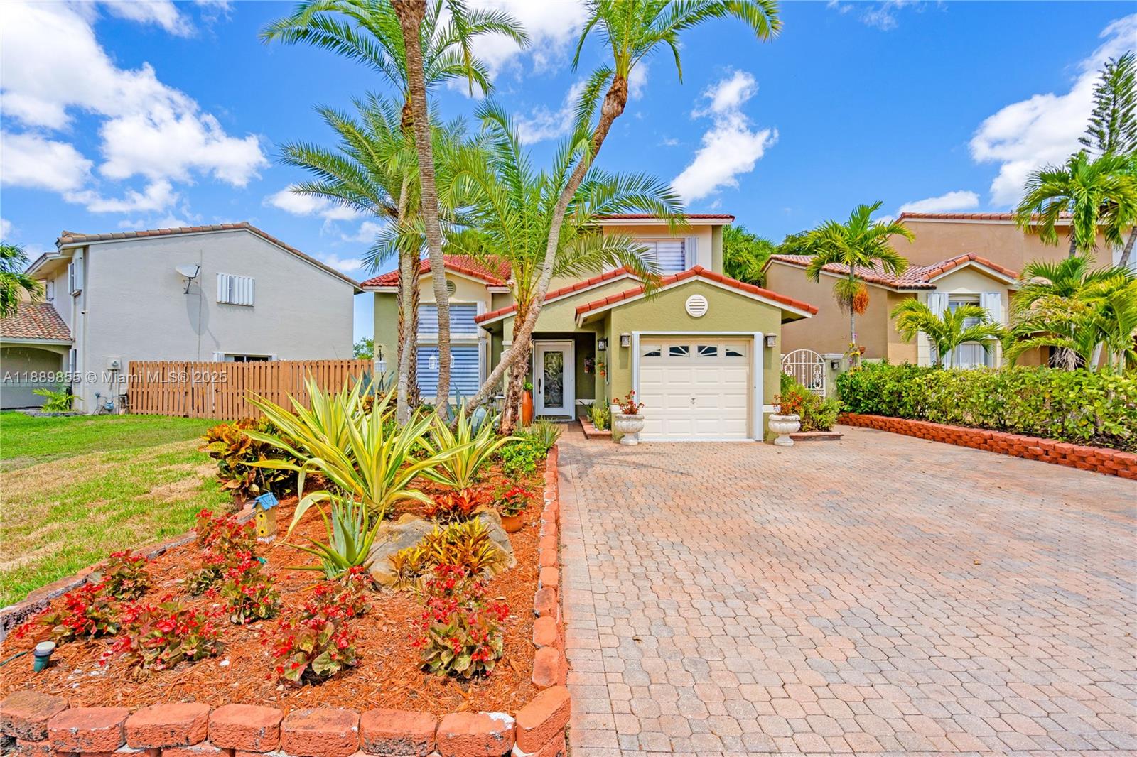 10213 Southwest 156th Avenue Miami, FL 33196 - Photo 3 of 29 a front view of a house with a garden