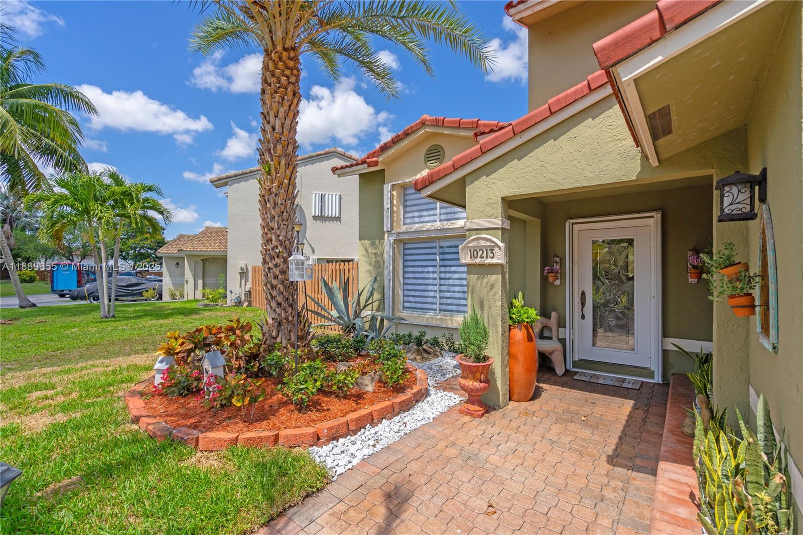 10213 Southwest 156th Avenue Miami, FL 33196 - Photo 4 of 29 a front view of a house with garden