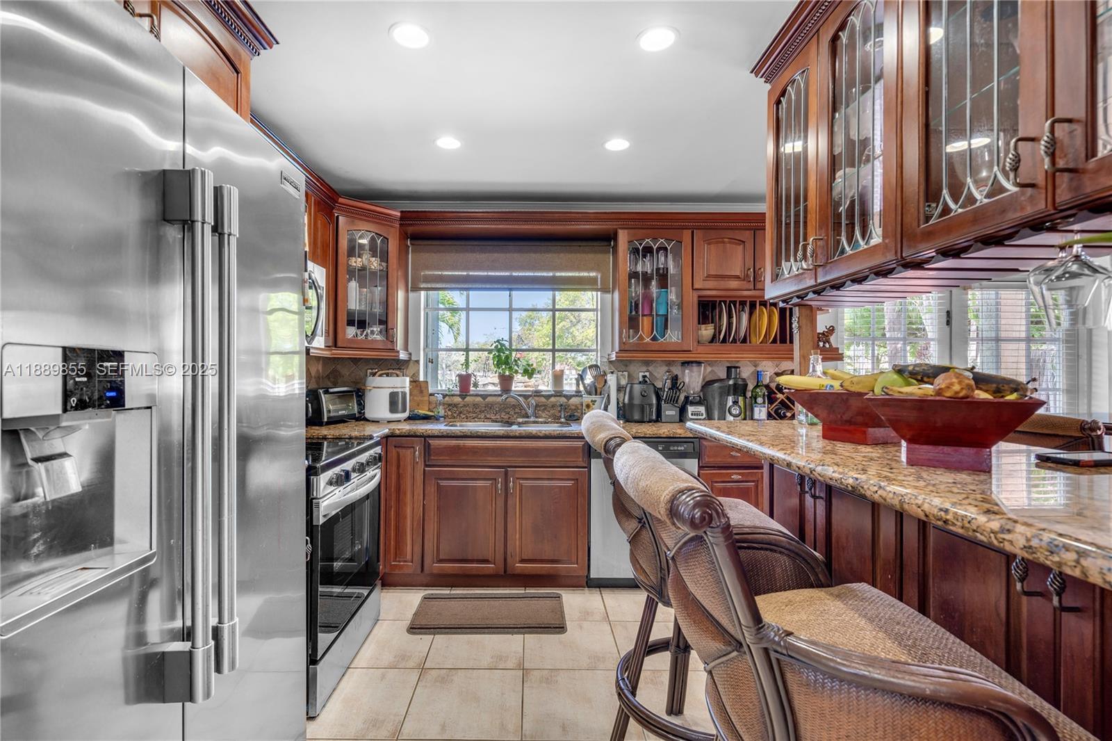 10213 Southwest 156th Avenue Miami, FL 33196 - Photo 9 of 29 a kitchen with stainless steel appliances granite countertop lots of counter top space