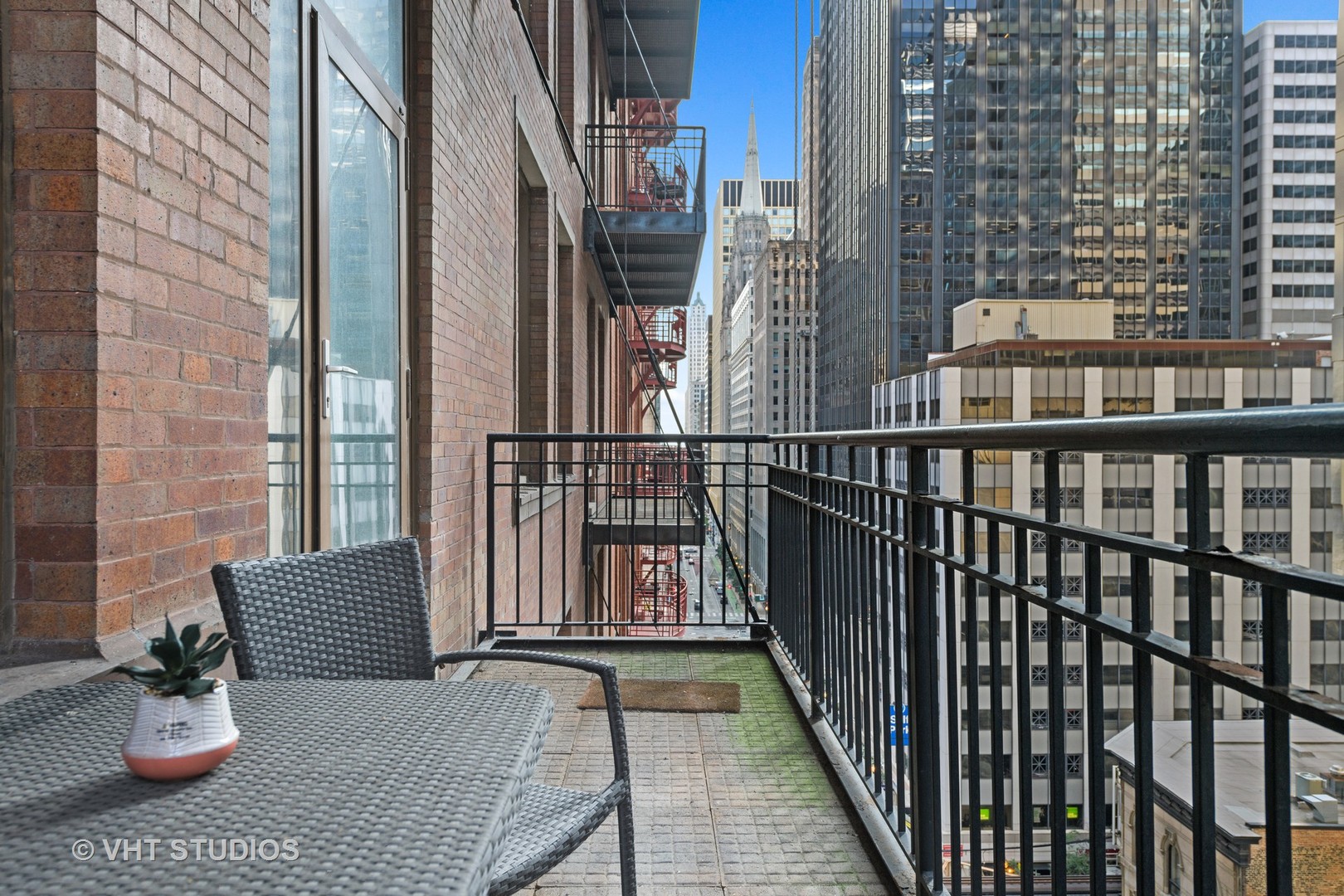 212 West Washington Street, Unit 1002 Chicago, IL 60606 - Photo 11 of 12 a view of a balcony with chair and potted plants