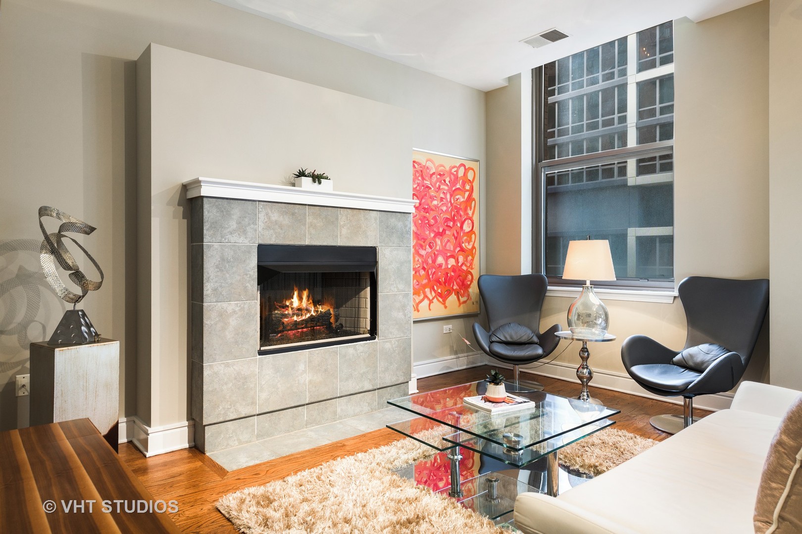 212 West Washington Street, Unit 1002 Chicago, IL 60606 - Photo 4 of 12 a living room with furniture and a fireplace