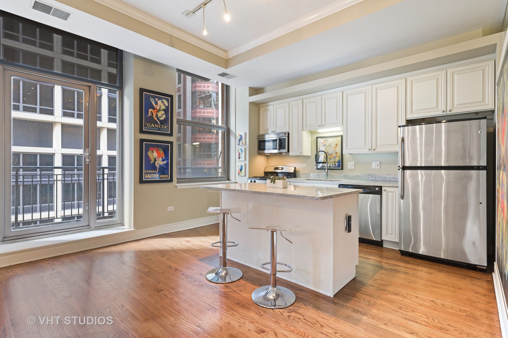 212 West Washington Street, Unit 1002 Chicago, IL 60606 - Photo 5 of 12 a kitchen with stainless steel appliances granite countertop a refrigerator a stove a sink and a microwave