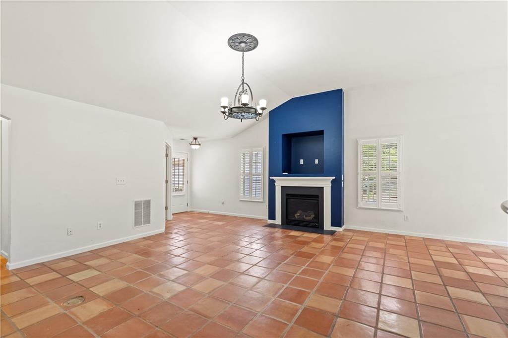 422 Arrowhead Trail Canton, GA 30114 - Photo 12 of 51 a view of a livingroom with a fireplace a chandelier and windows