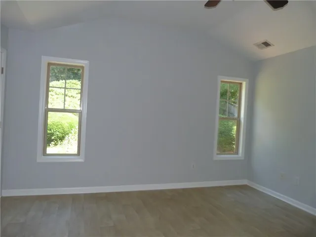 a view of room with a window and a ceiling fan