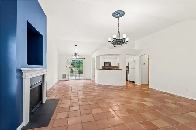 a view of livingroom with kitchen and fireplace