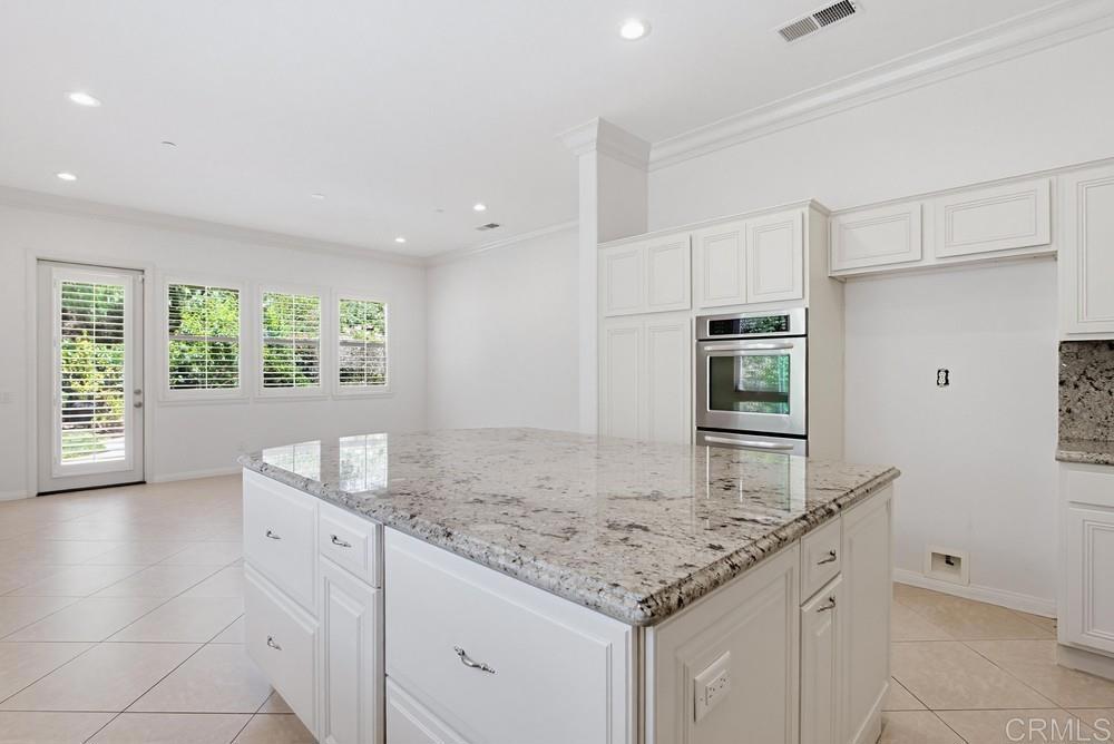 672 Inverlochy Drive Fallbrook, CA 92028 - Photo 23 of 75 a kitchen with granite countertop sink and cabinets