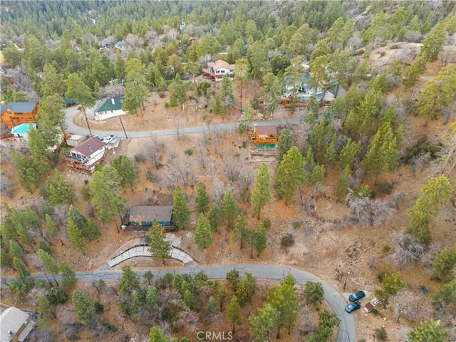 a aerial view of a houses with yard