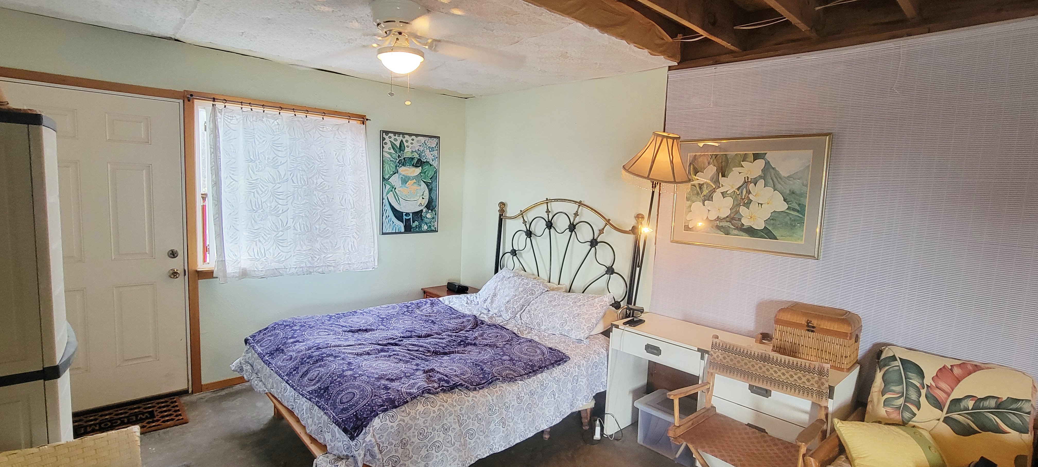 88-1520 Ehiku Avenue Captain Cook, HI 96704 - Photo 14 of 29 a bedroom with a bed and wooden floor