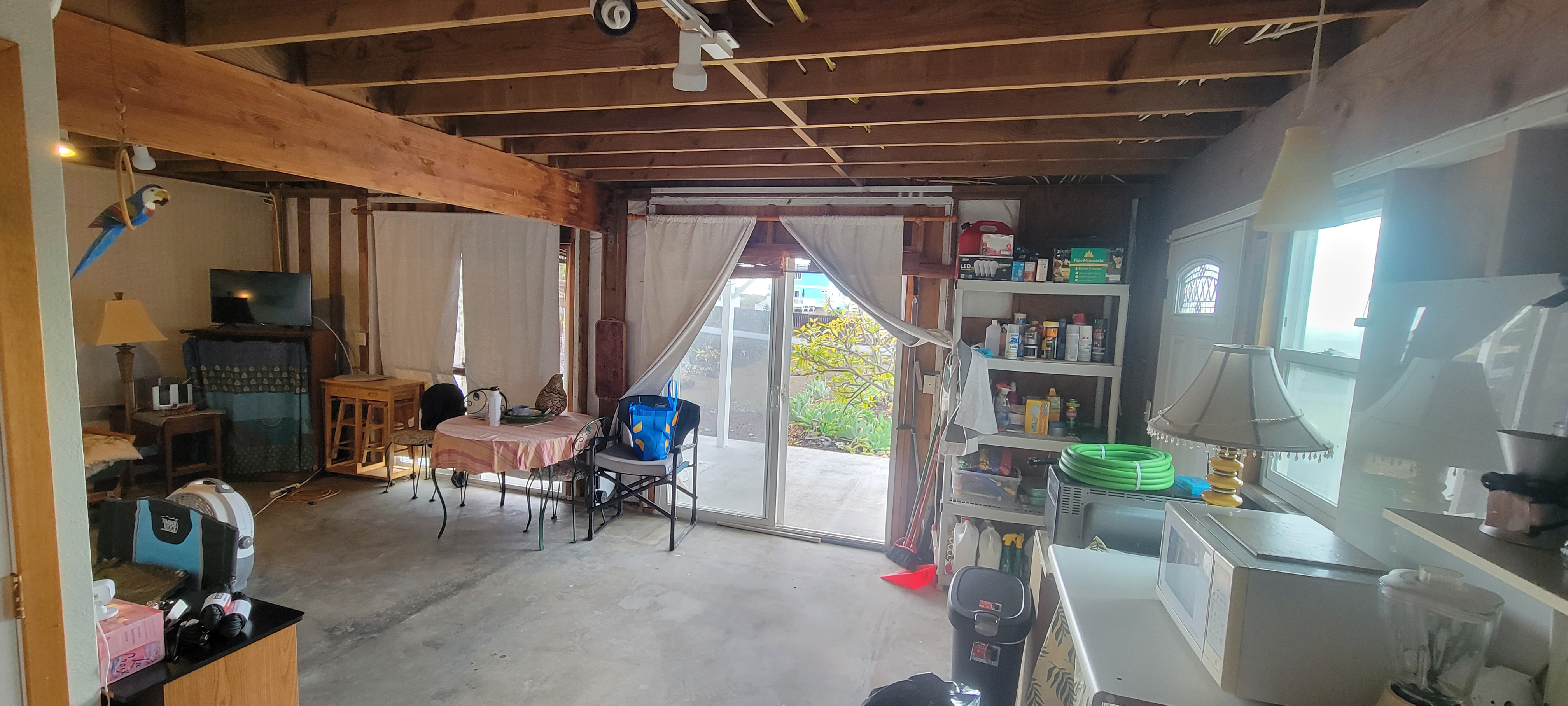 88-1520 Ehiku Avenue Captain Cook, HI 96704 - Photo 17 of 29 a living room with furniture a flat screen tv and a large window