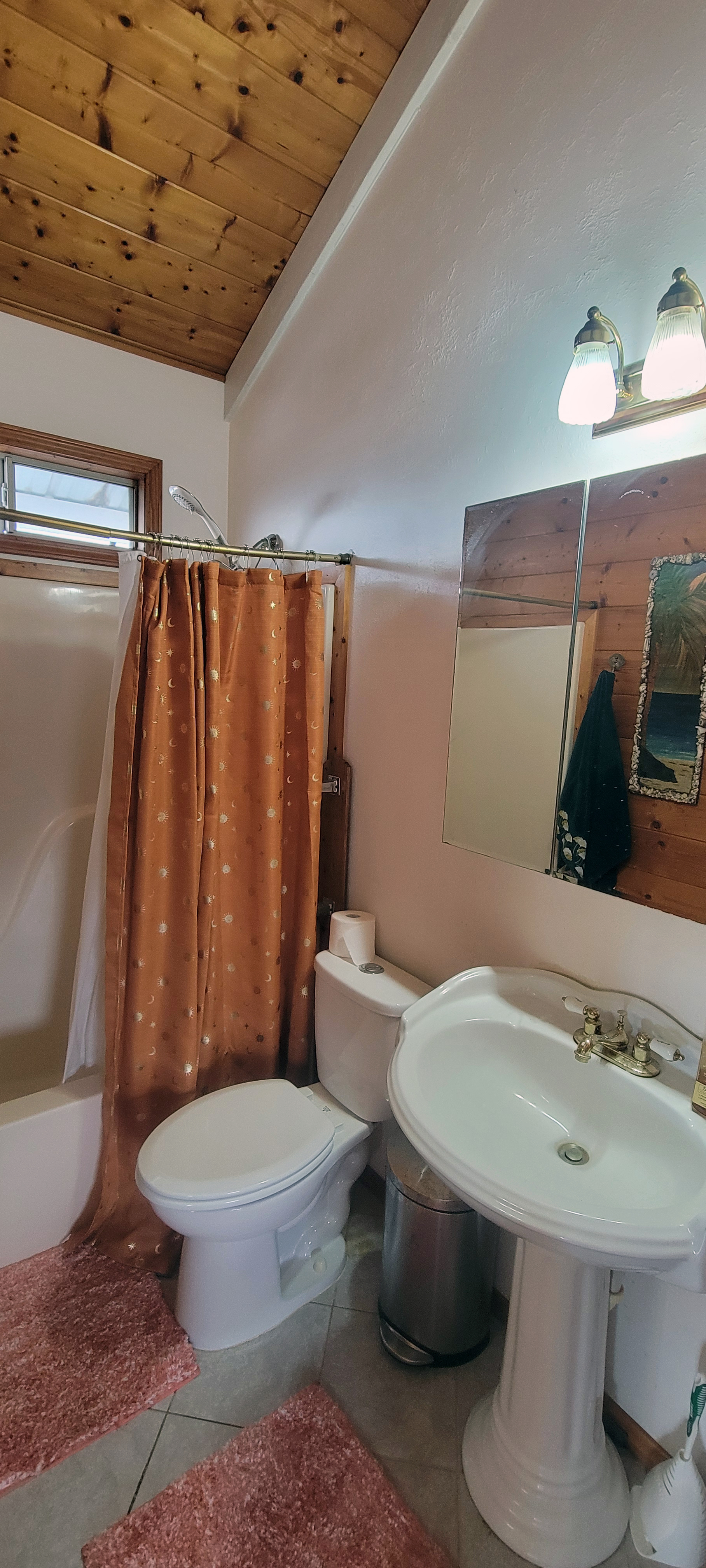 88-1520 Ehiku Avenue Captain Cook, HI 96704 - Photo 10 of 29 a white toilet sitting next to a bathroom sink and a mirror