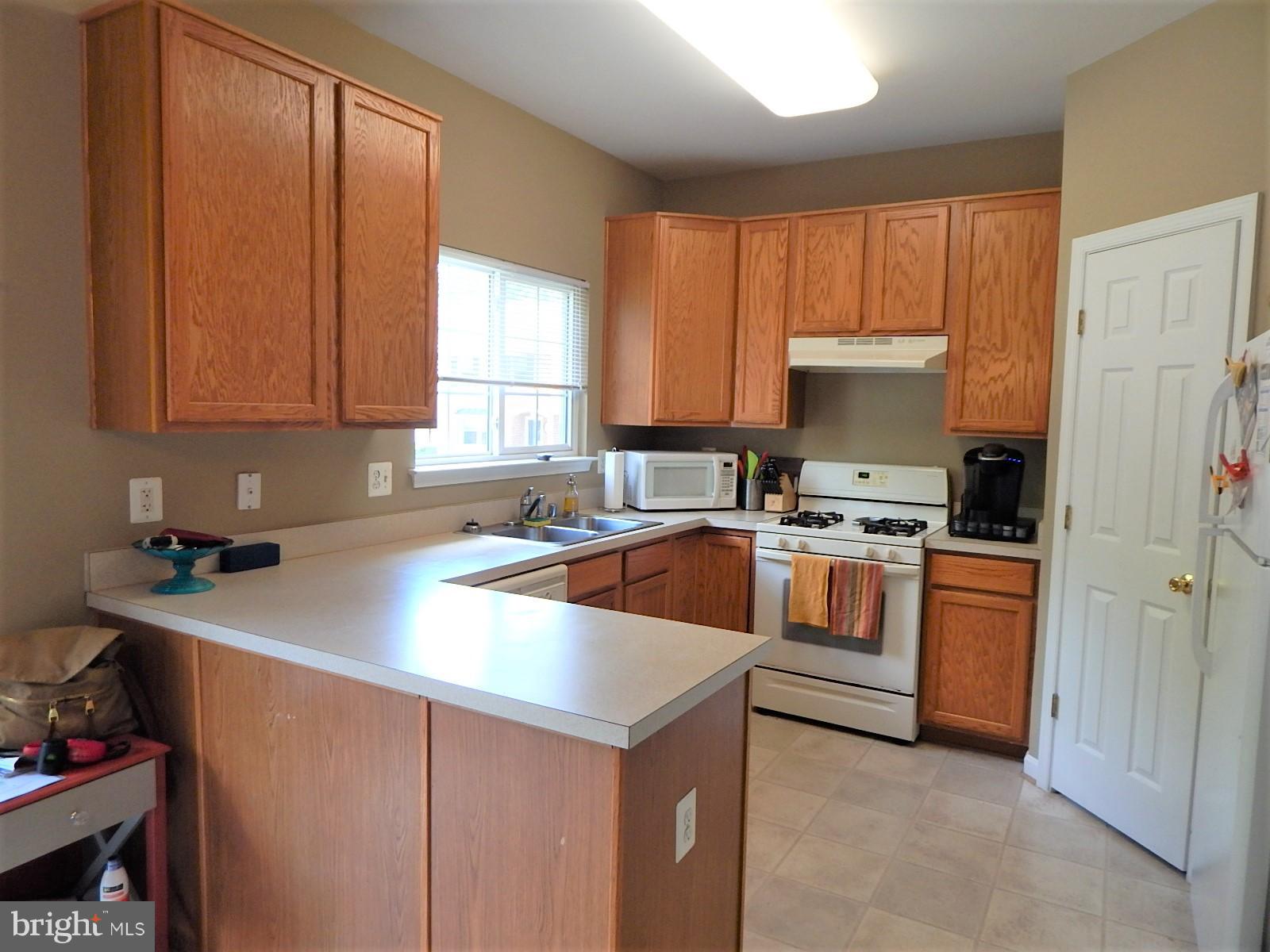 360 Snyder Lane Culpeper, VA 22701 - Photo 7 of 19 a kitchen with a stove a sink and a refrigerator
