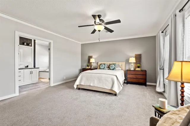 a spacious bedroom with a bed and a chandelier