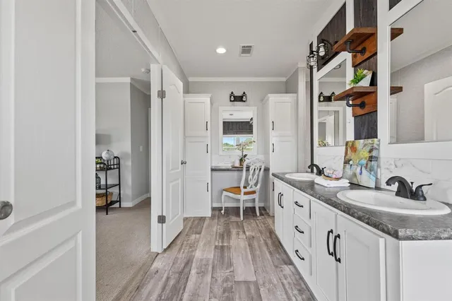 a bathroom with a sink a mirror and a shower