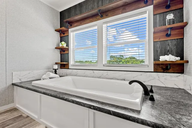 a bath tub sitting in front of a window
